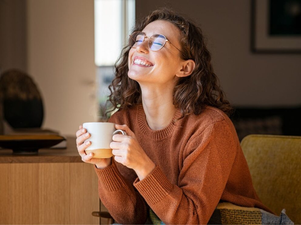 Smiling with a cup of coffee