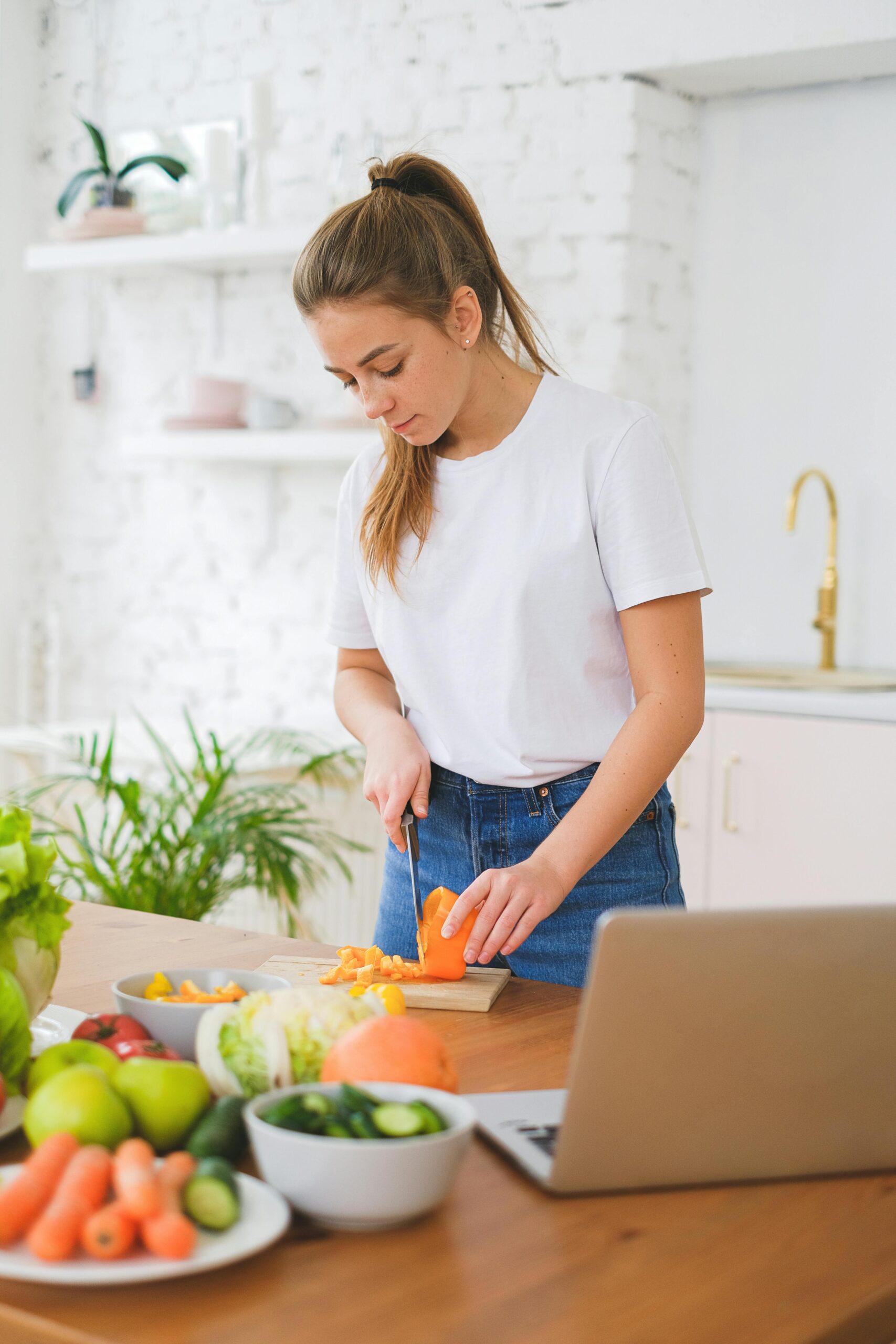 woman chopping up produce that helps fight oral cancer after visiting dentist bethesda, MD